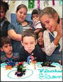Elian blows out birthday candle.