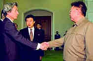 Kim, right, greets Koizumi, left
